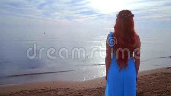 红发女人看着大海后景女子海滩在海边的女人视频的预览图