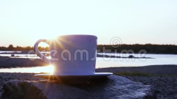 夕阳的光芒闪耀在一杯白咖啡的边缘特写镜头1920x1080高清视频的预览图