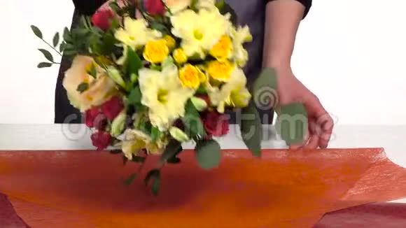 花匠为花束做包装白色的慢动作关门视频的预览图