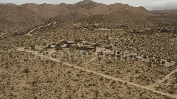 在沙漠中飞过树木和房屋视频的预览图
