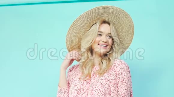 一个女孩戴着草帽和一件夏天的连衣裙转过来展示一件连衣裙视频的预览图
