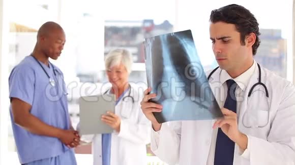 微笑的医生看着胸部X光视频的预览图