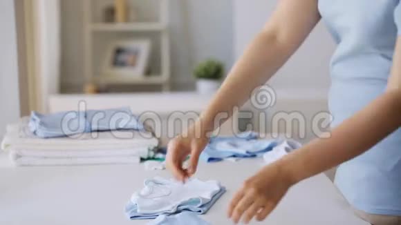 5孕妇在家折叠男婴的衣服6视频的预览图