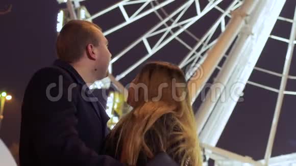 恋爱中的年轻人在摩天轮背景下接吻视频的预览图