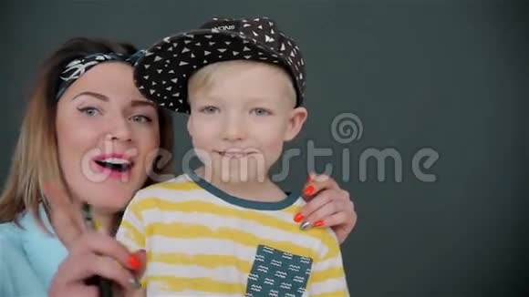一张儿子拥抱母亲的美丽肖像在灰色背景下被隔离视频的预览图