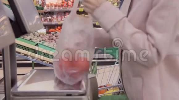 小女孩在超市里的甜椒秤上称重视频的预览图