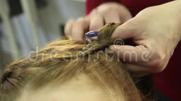 特写发型师做发型特写美发师在美容院为年轻女性做发型视频的预览图