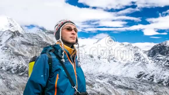 登山后穿蓝色夹克休息的年轻人的肖像视频的预览图