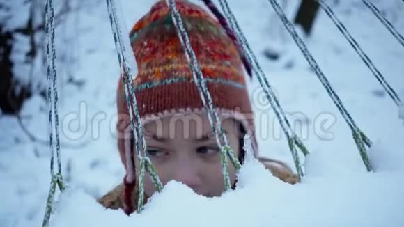 冬天男孩在吊床附近玩耍的肖像视频的预览图