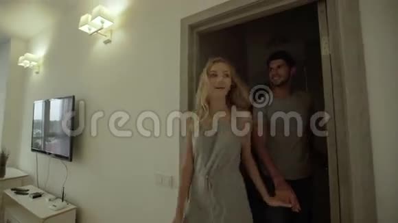 幸福的微笑情侣在他们美丽的新房子里跳舞视频的预览图