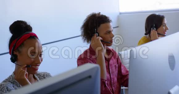 年轻的多民族客户销售主管在现代办公室用耳机交谈视频的预览图