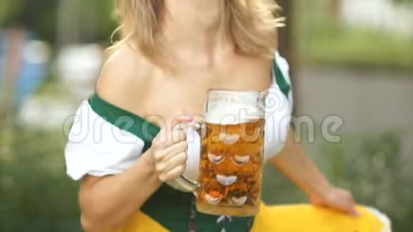 一个身穿巴伐利亚国服手里拿着一杯德国啤酒的女服务员行了个屈膝礼鞠躬开心地笑了视频的预览图