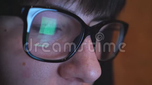 戴眼镜的年轻女人看着智能手机上网手机屏幕反映在视频的预览图