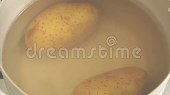 顶部的景色土豆沸水和旋塞在钢锅烹饪蒸汽近距离射击视频的预览图