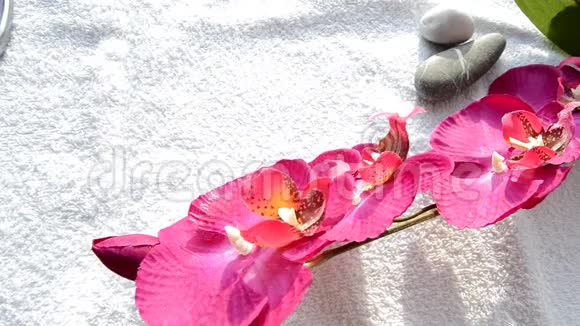 水疗指甲兰花和白色背景石头的配件和工具视频的预览图