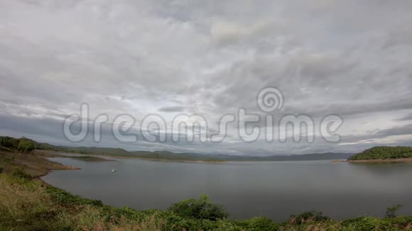 太阳和云层的反射在天空中快速移动背景山和水在彭查布里的开克拉昌大坝视频的预览图