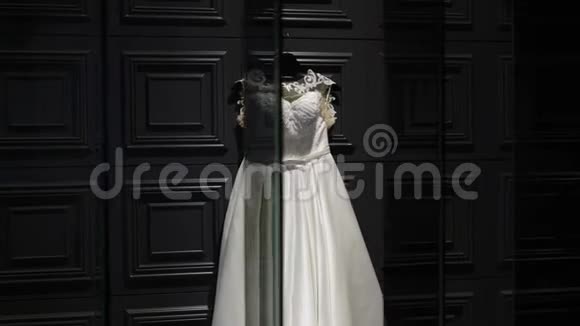 白色婚纱在黑暗的墙上镜子里的倒影视频的预览图