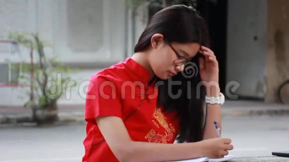 泰国少年漂亮女孩穿着中国服装写了一本书视频的预览图