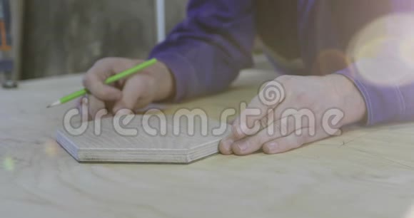 木匠的手在大木板上勾勒出一件家具视频的预览图