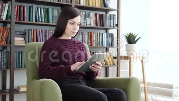 令人震惊的受惊的女人用平板电脑浏览视频的预览图