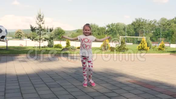 体育场附近的微笑女孩跳绳子缠在绳子上然后又开始跳跃视频的预览图