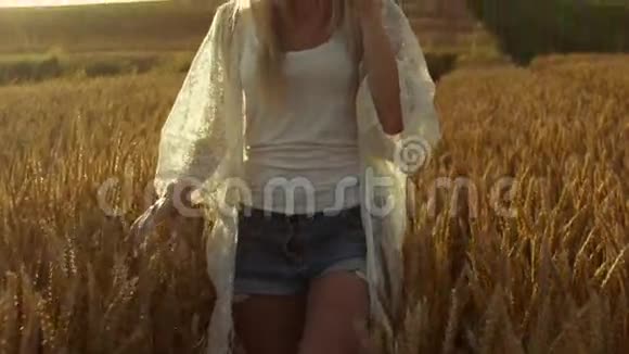 微笑的金发女孩奇迹穿越麦田时尚的女人阳光灿烂慢动作稳定射击视频的预览图