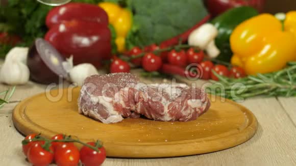 厨师戴着黑色手套把肉洒在木板上上面有胡椒背景是蔬菜视频的预览图