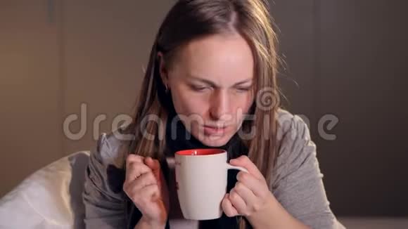 年轻女子喝热茶的画像特写镜头4K视频的预览图