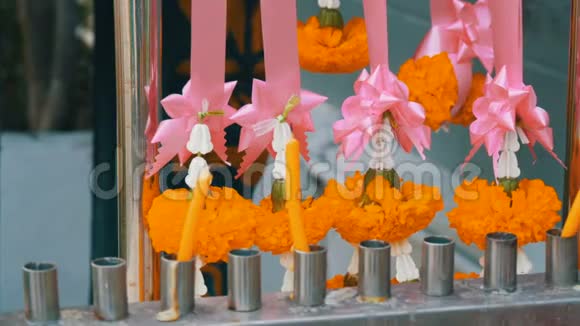 泰国传统佛教祭坛附近的蜡烛和鲜花视频的预览图