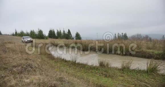 山地休闲秋天的歌声极端三菱帕杰罗越野车快速驶入山上的沼泽视频的预览图