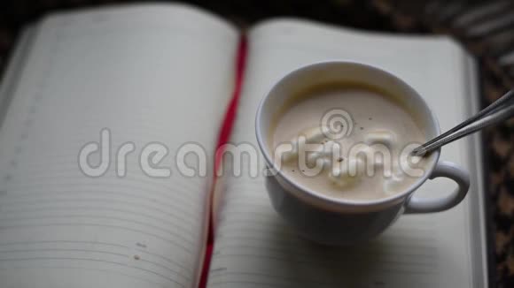早晨咖啡在笼子里的棕色格子布背景下倒入杯中视频的预览图