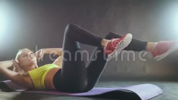 健身室里有魅力的女人做腹部运动视频的预览图
