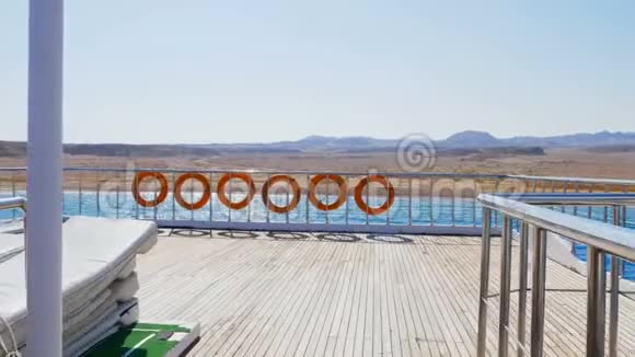 夏天海上一架摄像机沿着渡轮甲板飞行船上挂着许多橙色的救生圈视频的预览图