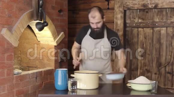 男面包师将配料倒入锅中揉面团视频的预览图
