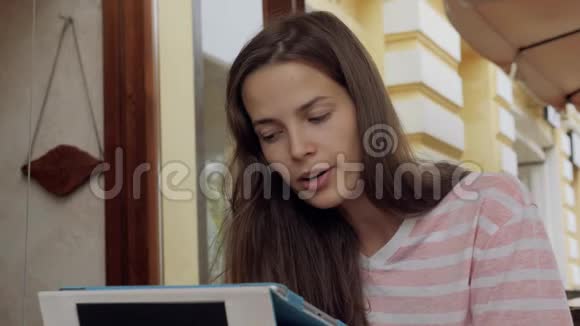 坐在咖啡馆里学习的年轻女子学生作业视频的预览图