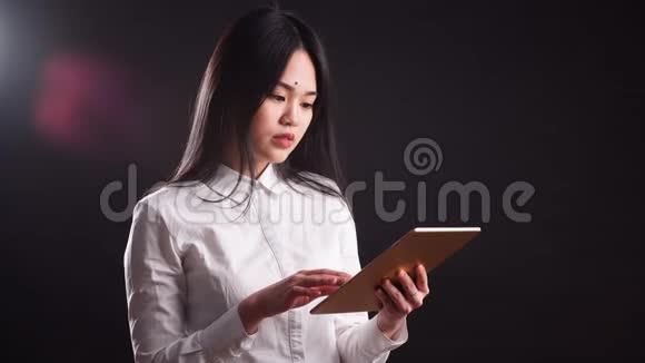 年轻快乐的亚洲女性使用数字平板电脑的肖像孤立视频的预览图