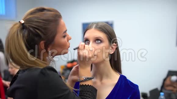 时装秀视觉师工作专业化妆后台女模特漂亮的脸化妆视频的预览图