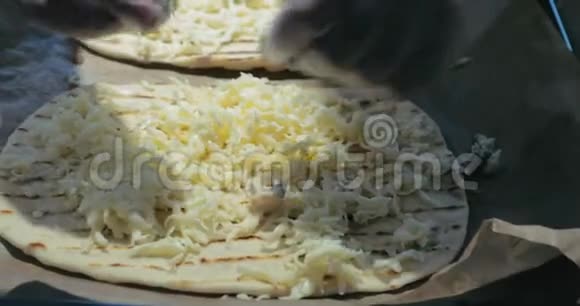 戴乳胶手套的厨师在烤盘上展示比萨饼的面团在面团上展示不同的奶酪面团在纸上传播视频的预览图