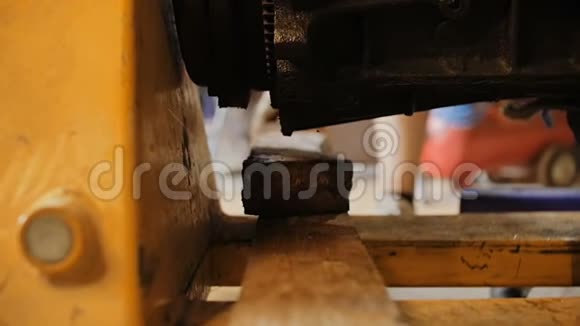 汽车车间机械师在汽车发动机下面铺一根木梁以便进一步运输视频的预览图