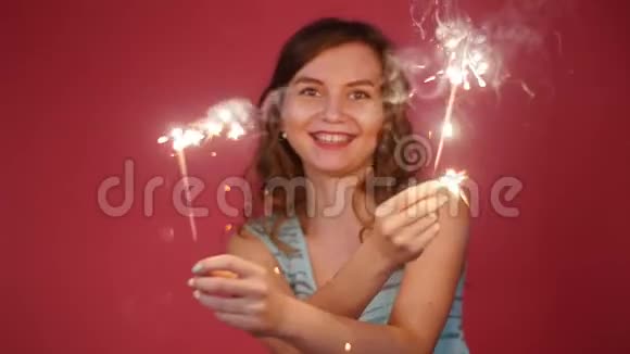 一位美丽的微笑女人带着火花跳舞视频的预览图