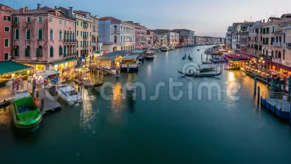 大运河在威尼斯意大利日夜流逝从里尔托桥可以看到贡多拉斯和城市灯光视频的预览图
