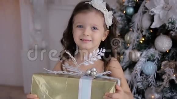 穿着白色连衣裙的小女孩捧着新年礼物视频的预览图