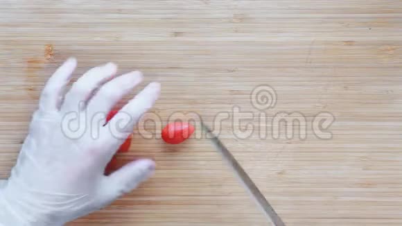 厨师在木制砧板上切樱桃西红柿俯视图视频的预览图