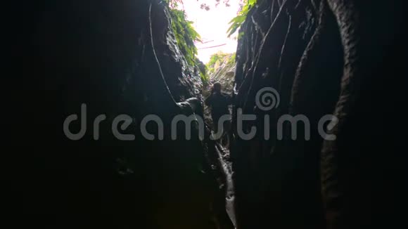 人站在黑暗狭窄的峡谷照片在背光视频的预览图
