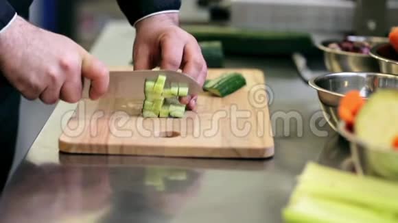 男性厨师在厨房切黄瓜的手视频的预览图