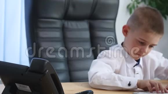 小男孩在办公室打电话喝果汁视频的预览图