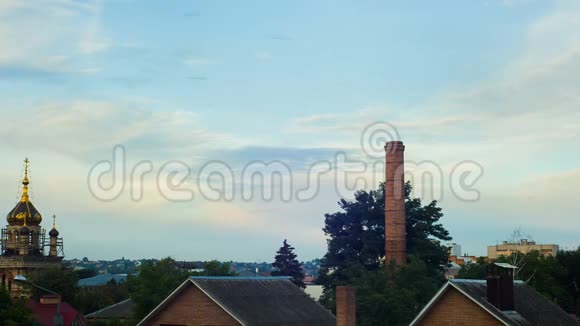 白天在城市的房屋上方睡觉白云在蓝天上移动视频的预览图