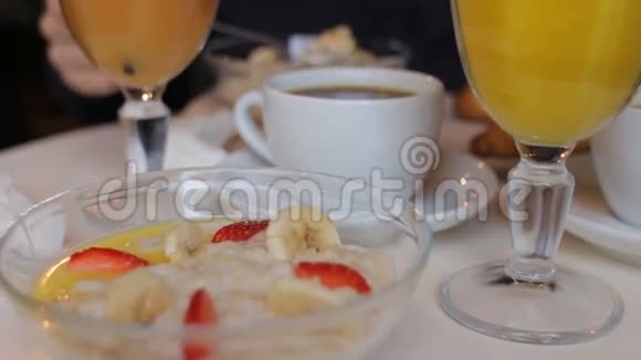 在咖啡馆里吃美味早餐的人粥鲜橙汁咖啡茶视频的预览图