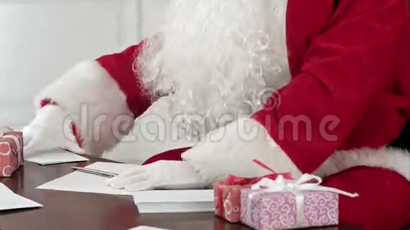 圣诞老人坐在他的桌子上给圣诞老人回信视频的预览图
