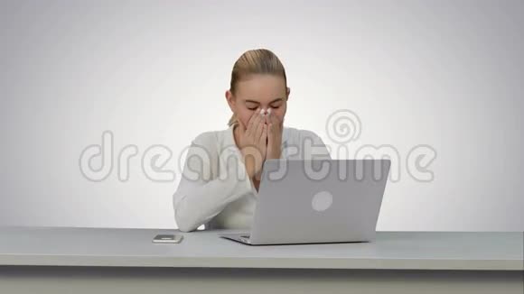 年轻的秘书在工作场所累了在白色的背景上打哈欠视频的预览图